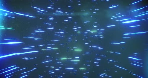 Blue and green light trails spinning against black background