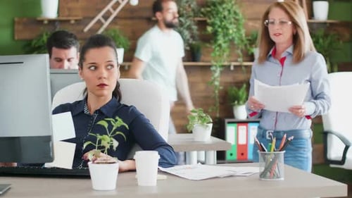 Successful Young Business Sitting at Her Office Working on Computer