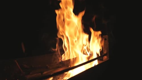Bright Flames Burning in a Fire Pit at Night