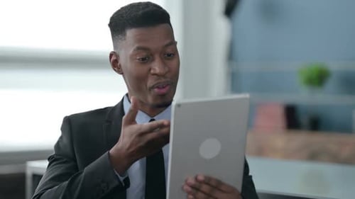 Portrait of Video Call on Tablet by African Businessman in Office