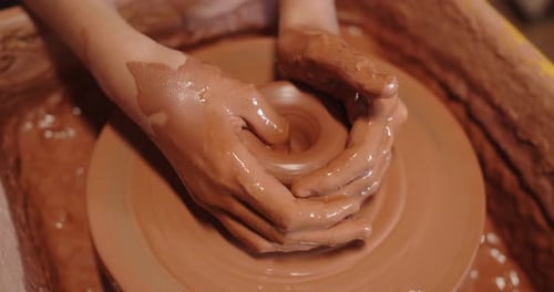 Hands Forming Clay on Pottery Wheel