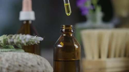 Dropping Essential Oil into Bottle, Close Up