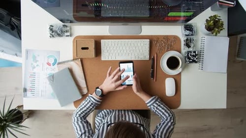 Busy Businesswoman Using Smartphone at Workplace