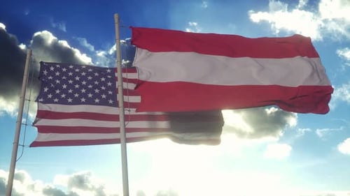 United States and Austrian National Flags Waving Against Blue Sky