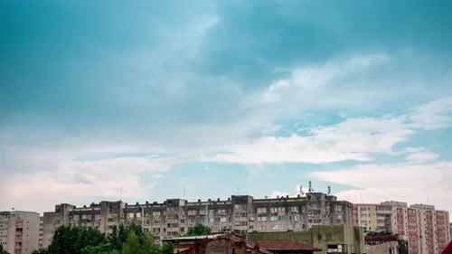 Fast Moving Storm Clouds Over Buildings in Residential Area