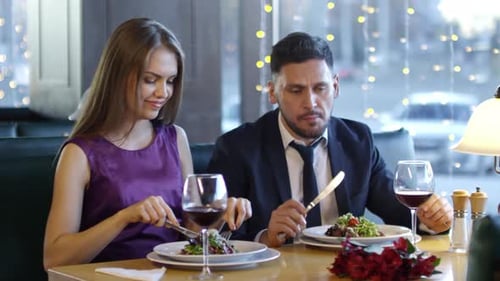 Couple Having Dinner at Elegant Restaurant