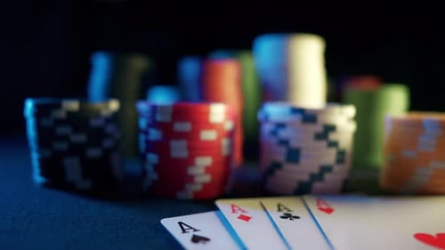 Casino Chips with Dice and Playing Cards on a Dark Table