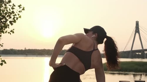 Back View of a Fit Sport Woman Stretching Her Body Warm Up Before Workout Outdoor