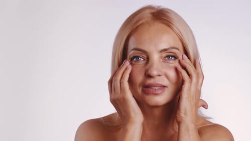 Woman Massaging Face and Eyes for Beauty