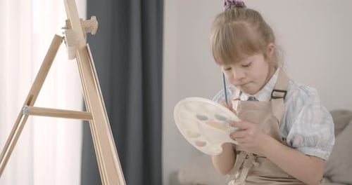 Child Painting at Easel in Home Interior