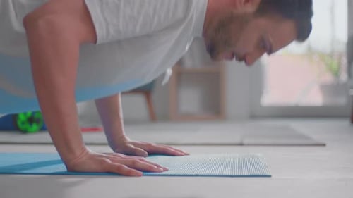 Muscular Man Doing Push Ups on Yoga Mat