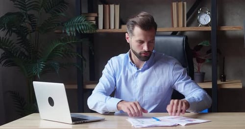 Man Working at Laptop in Modern Office Environment