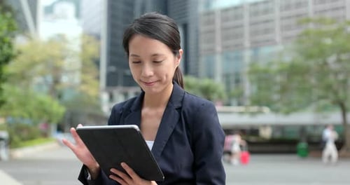 Woman Using Tablet Outdoors in City
