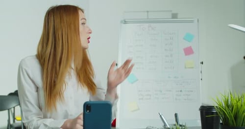 Female Teacher Giving Online Presentation from Office