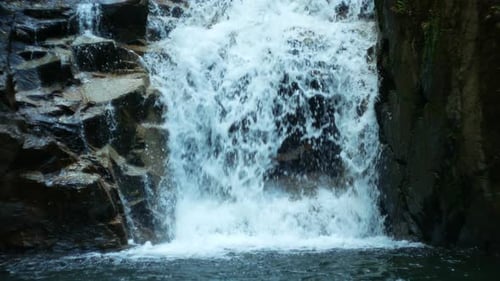 Picturesque Waterfall Flowing Down Rocks Into Pool
