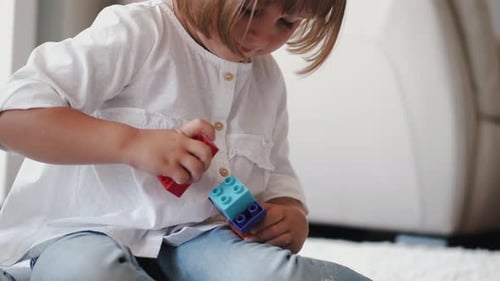 Cropped View of Designing Construction From Colorful Bricks at Home