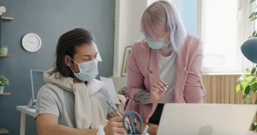 Colleagues Discussing Work Wearing Face Masks