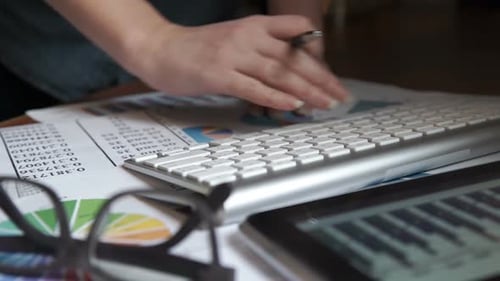 Hands Typing on Keyboard and Touching Tablet