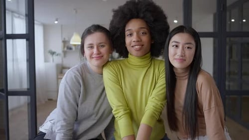 Three Young Women Friends Smiling Indoors