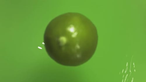 Lime Dropping Into Water and Being Cut