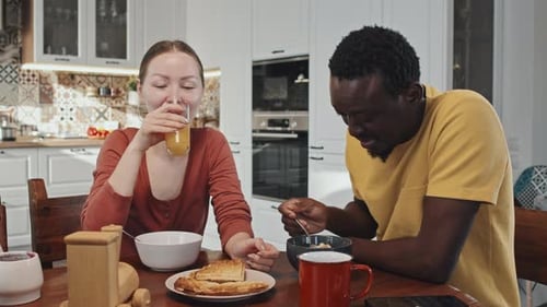 Couple Eating Breakfast at a Kitchen Table