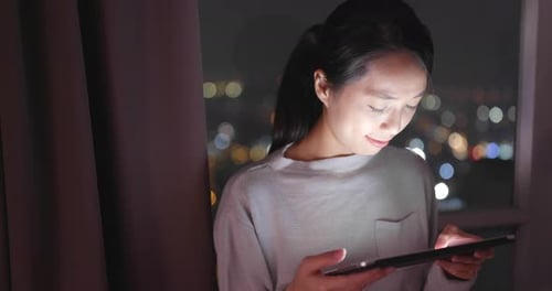 Woman Using Tablet at Night, City Lights