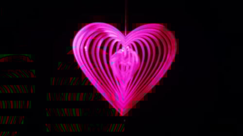 Pink Heart Ornament Hanging on Black Background
