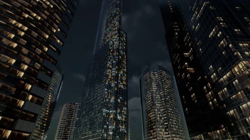 Edificios de oficinas de rascacielos de cristal con cielo oscuro