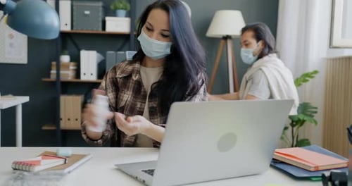 Adults Working at Desks in Brightly Lit Office