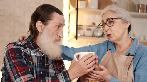 Loving Elderly Couple Together in a Kitchen