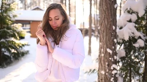 Woman Outdoors in Winter Forest Warms Hands