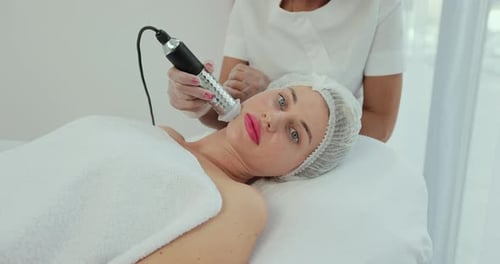 Beautiful Woman Lying at Spa and Having Facial Procedures