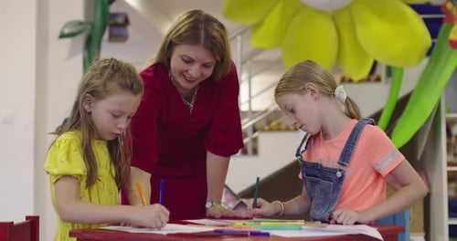 Creative Kids During an Art Class in a Daycare Center or Elementary School Classroom Drawing with