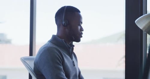 Man in Headset Talking in Modern Office