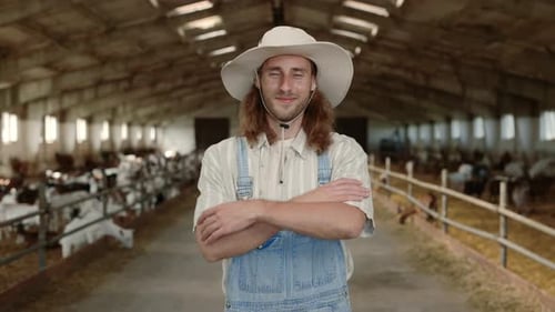 Male Farmer Standing with Crossed Arms at Goat Farm