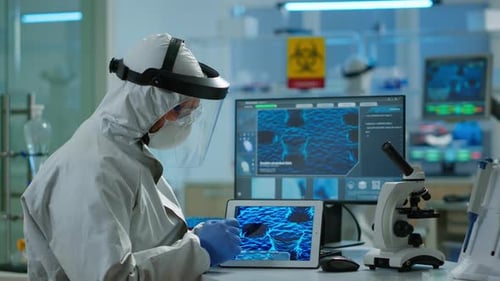 Chemists in Coverall Working To Develop Vaccine Using Tablet