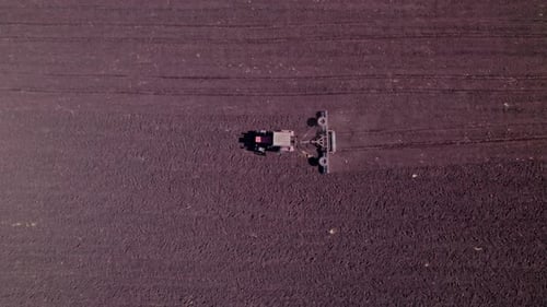 Tractor in the Dust Working in the Field