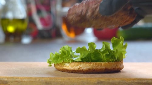 Making Delicious Hamburger with Lettuce, Cheese, and Vegetables