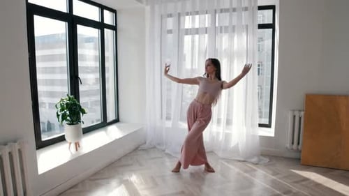 Woman Dances Gracefully in Modern Apartment