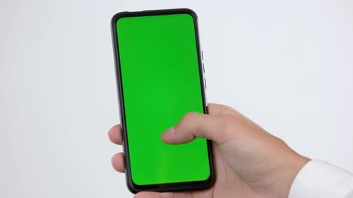 Hand of Man Using Smartphone with Green Chroma Key Screen