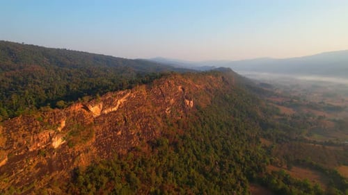 4K aerial view over mountain scenery rural Thailand at sunset