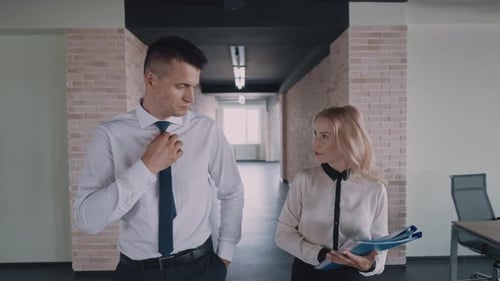 Business Professionals Walking Through Office Talking