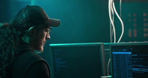 Focused Young Adult Coding at Night