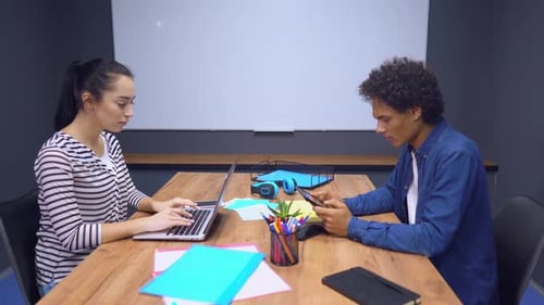 Young Adults Working at an Office Desk