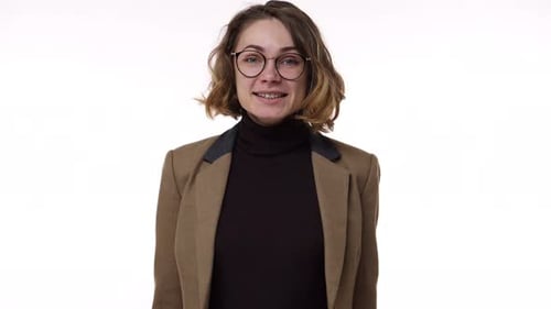 Beautiful Young Woman in Brown Jacket Smiles and Shows Thumbs Up Gesture Ank OK Winking Isolated on