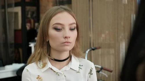 Woman Getting Makeup Applied in a Salon
