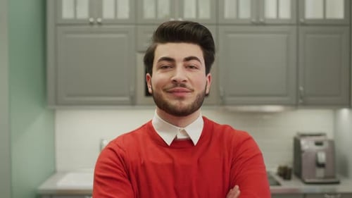 Confident Young Man With Beard Smiling in Kitchen