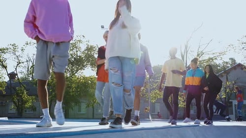 Diverse Group Teens Walking in Skatepark Sunlight
