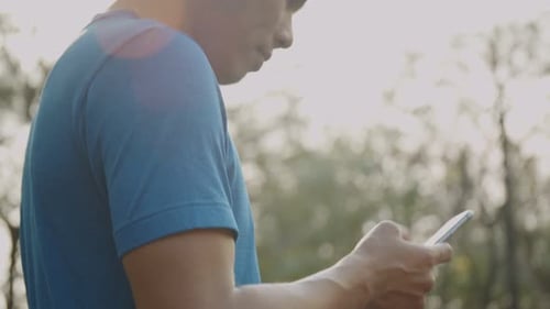 Close up hands typing a message on a smartphone.
