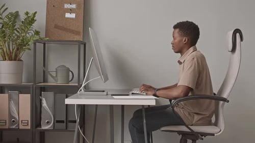 African American Man with Labrador in Office